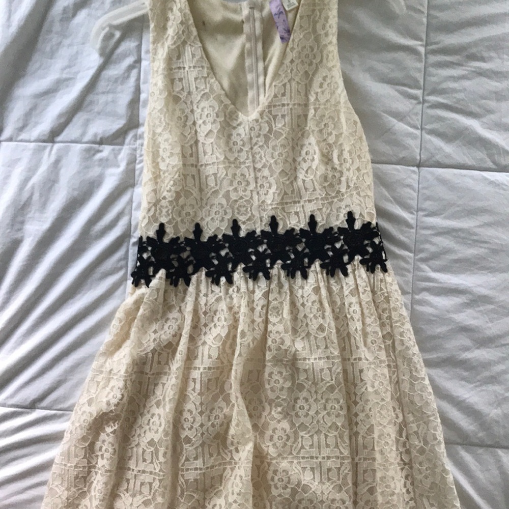 Cream, lace dress with black lace detailing.